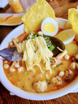 Savor the warmth of Thai laksa: creamy broth, lush noodles, and vibrant herbs, in a casual Fort Wayne eatery.