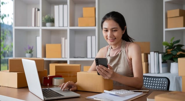 Smiling young woman in warehouse scanning package with smartphone.