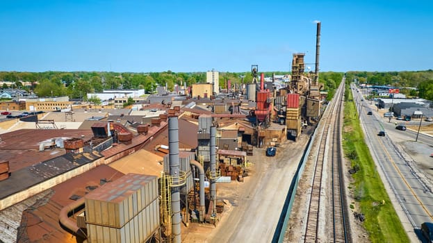 Aerial view of a bustling industrial complex in Warsaw, Indiana, showcasing robust activity and vital logistics links.