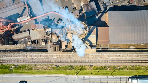 Aerial view of an industrial complex in Warsaw, Indiana, showcasing heavy machinery and everyday urban life.