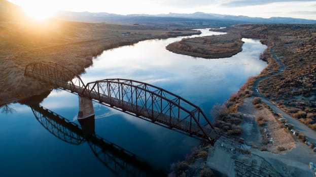 bridge going over a river during sunset