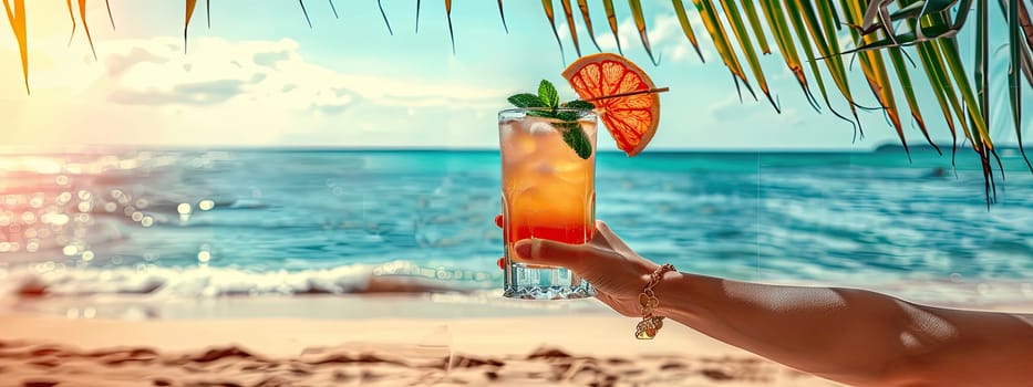 A cocktail in the hands of a girl on the beach. Selective focus. Drink.