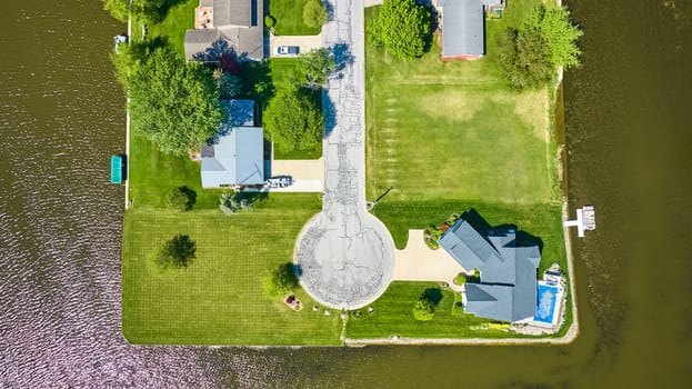 Aerial view of a luxurious suburban neighborhood in Warsaw, Indiana, with a scenic lakeside setting.