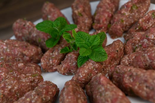 RECIPE FOR LEBANESE KEBBE NAYYHE, RAW MINCED BEEF, MARJORAM, MINT, ONIONS, CRUSHED WHEAT, SEVEN SPICES, CINNAMON, CAYENNE PEPPER. High quality photo