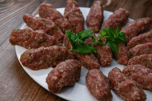 RECIPE FOR LEBANESE KEBBE NAYYHE, RAW MINCED BEEF, MARJORAM, MINT, ONIONS, CRUSHED WHEAT, SEVEN SPICES, CINNAMON, CAYENNE PEPPER. High quality photo