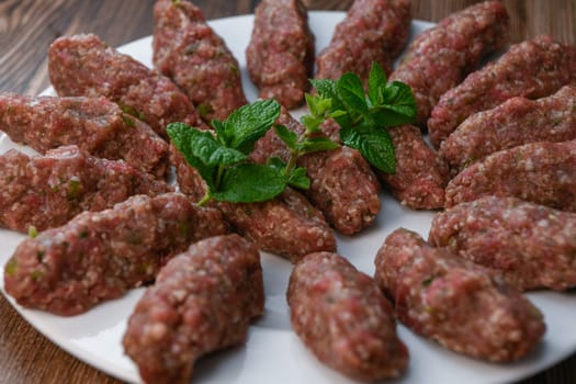 RECIPE FOR LEBANESE KEBBE NAYYHE, RAW MINCED BEEF, MARJORAM, MINT, ONIONS, CRUSHED WHEAT, SEVEN SPICES, CINNAMON, CAYENNE PEPPER. High quality photo