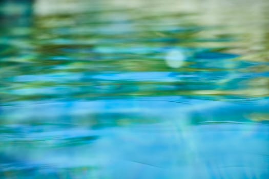 Serene water motion in abstract blues and greens, reflecting sunlight and evoking calmness, perfect for creative and wellness themes.