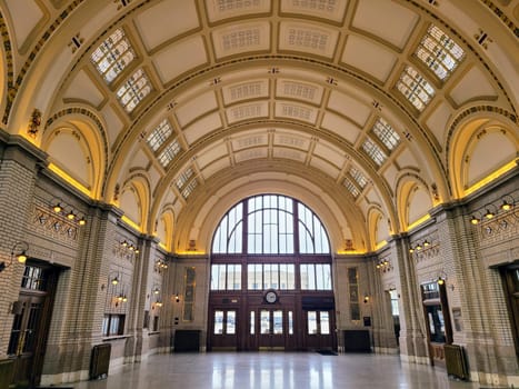 Historic Fort Wayne train station interior with classical architecture and stained-glass windows.