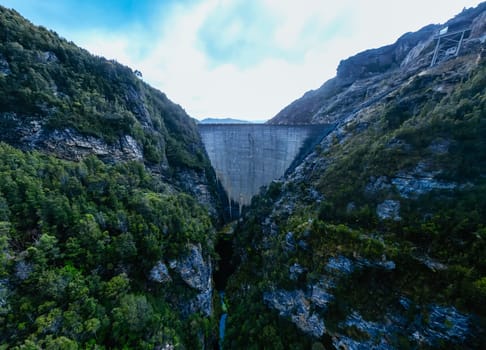 View of the Gordon Dam on a cool summer's day. It is a unique double curvature concrete arch dam with a spillway across the Gordon River near Strathgordon, South West Tasmania, Australia