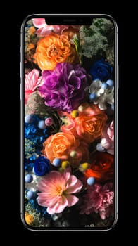 Smartphone screen: Smartphone with colorful flowers isolated on black background, close-up