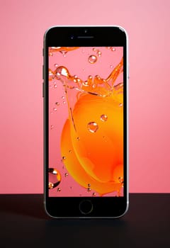 Smartphone screen: Smartphone with orange and water drops on the screen. 3d rendering