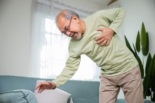 Senior man bad pain hand touching chest having heart attack, Asian older man have congenital disease suffering from heartache alone at home his heart aches, Old age retirement health problems diseases