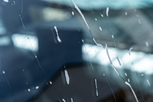 Denver, Colorado, USA-May 5, 2024-A close-up view of a Tesla Cybertruck covered in soap suds during a car wash, showcasing the flowing patterns over its angular surface and highlighting the unique design of the vehicle body.