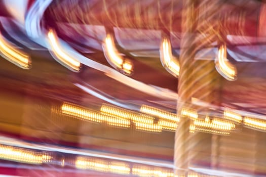 Vibrant carousel lights blur into a swirl of excitement at Fort Wayne Children's Zoo, Indiana.