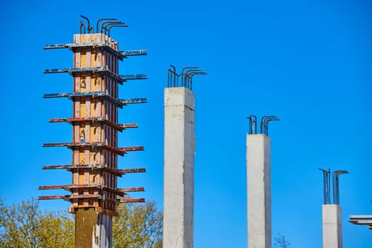 Rising concrete columns under blue skies, illustrating construction progress in downtown Fort Wayne, Indiana.