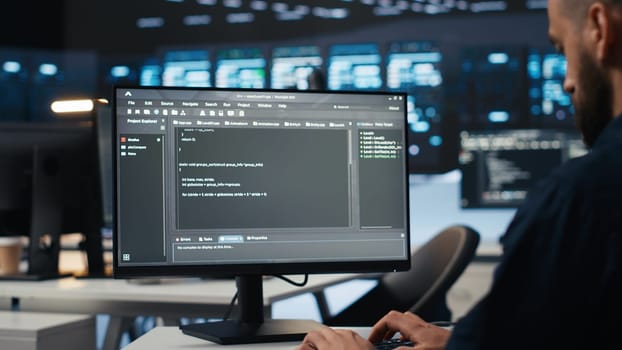 IT employee programming in server hub housing supercomputers storing datasets. Close up shot of expert typing code on computer to mend data center racks doing complex computational operations