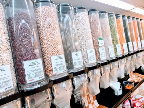 Bright and organized bulk food section with a variety of beans in Fort Wayne, Indiana, promoting sustainable shopping.
