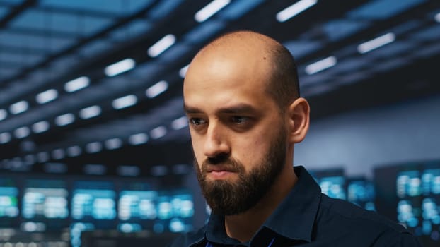 Admin in server hub writing code, ensuring data remains shielded from threats. Close up shot of IT engineer safeguarding supercomputers against unauthorized access, securing system from hackers