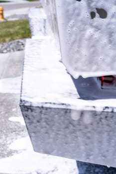 Denver, Colorado, USA-May 5, 2024-This image captures soapy water streaming beautifully down the metallic, angular side of a Tesla Cybertruck during a wash. The close-up showcases the sleek lines and unique design of the vehicle.