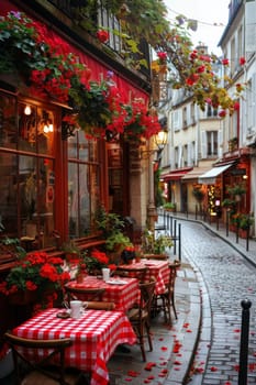 A red and white checkered table with a red and white tablecloth is set up on a cobblestone street. The table is surrounded by chairs and potted plants. The scene is reminiscent of a cozy outdoor cafe