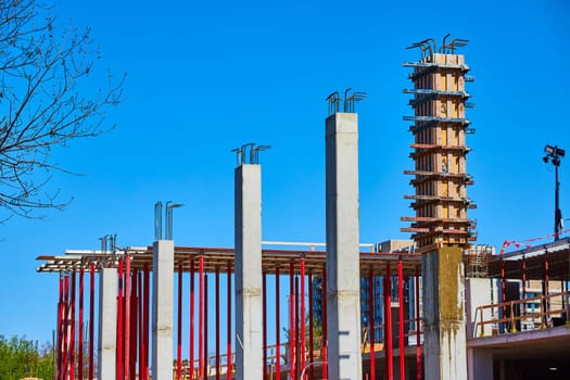 Rising construction site in Fort Wayne, showcasing modern urban development under a clear blue sky.