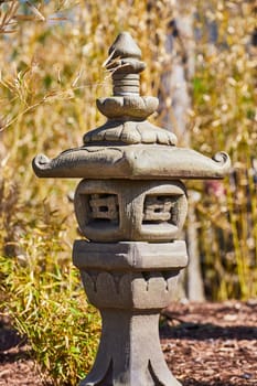 Traditional East Asian stone lantern in serene garden setting at Fort Wayne, Indiana, emphasizing tranquility and culture.