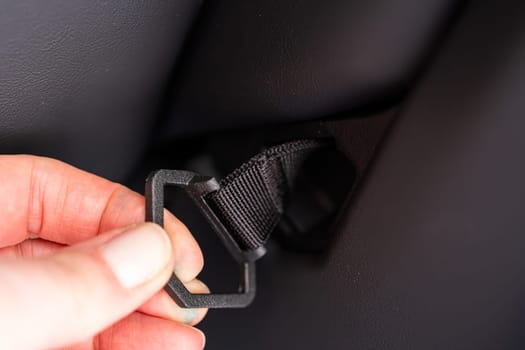 Denver, Colorado, USA-May 5, 2024-This image shows a detailed view of the back seat release pull strap in a Tesla Cybertruck, emphasizing the subtle yet functional design integrated within the vehicle interior.