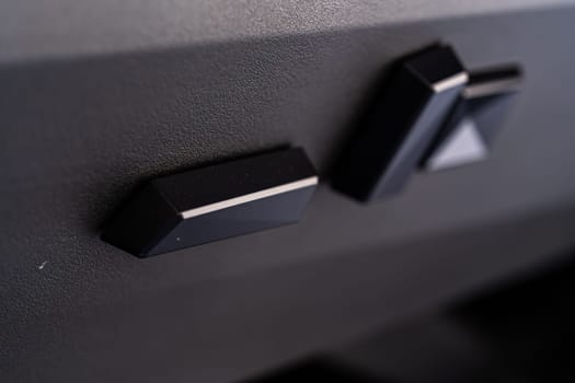 Denver, Colorado, USA-May 5, 2024-This image captures a close-up view of the seat adjustment buttons located in the Tesla Cybertruck, emphasizing the minimalist and sleek design of the vehicle interior controls.