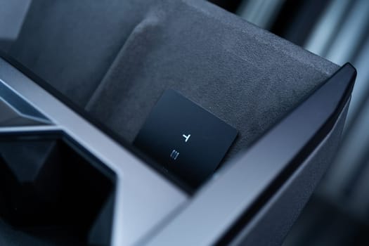 Denver, Colorado, USA-May 5, 2024-his image captures the sleek Tesla Cybertruck key card positioned neatly in the vehicle card holder, highlighting its minimalist design and emphasizing the modern aesthetic of Tesla innovative features.