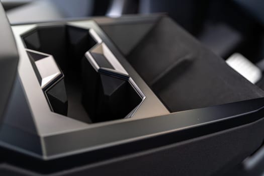 Denver, Colorado, USA-May 5, 2024-This image captures the innovative design of the cupholder inside the Tesla Cybertruck, showcasing its unique angular shapes and modern, minimalist aesthetic.