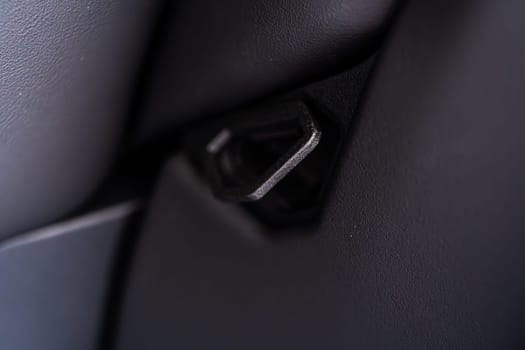 Denver, Colorado, USA-May 5, 2024-This image shows a detailed view of the back seat release pull strap in a Tesla Cybertruck, emphasizing the subtle yet functional design integrated within the vehicle interior.