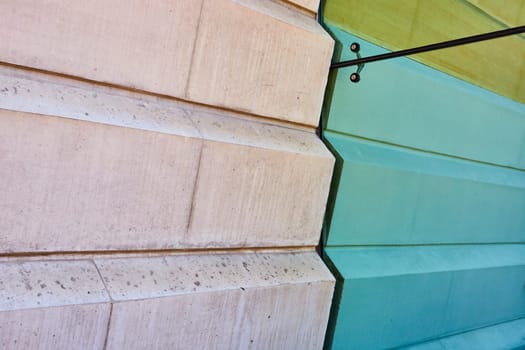 Modern and rustic blend in downtown Fort Wayne: beige stone meets sleek mint-green paneling.