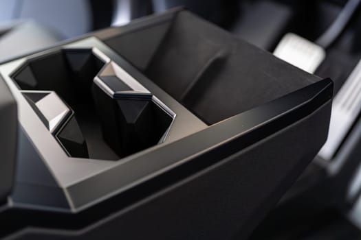 Denver, Colorado, USA-May 5, 2024-This image captures the innovative design of the cupholder inside the Tesla Cybertruck, showcasing its unique angular shapes and modern, minimalist aesthetic.