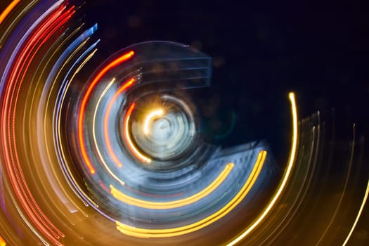 Vibrant light trails swirl in a mesmerizing pattern during a night exposure in downtown Fort Wayne, Indiana.