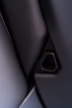 Denver, Colorado, USA-May 5, 2024-This image shows a detailed view of the back seat release pull strap in a Tesla Cybertruck, emphasizing the subtle yet functional design integrated within the vehicle interior.