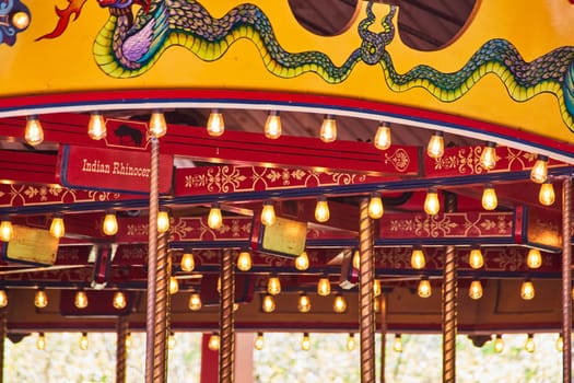 Enchanted evening at Fort Wayne Children's Zoo: Illuminated vintage carousel with a vivid dragon canopy.