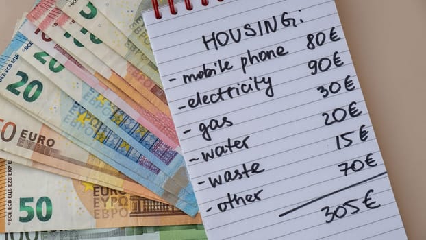 Counting expenses bills on housing electricity, gas, water. Banknotes of euro cash around. High prices for energy inflation crisis. Cut back on spending. Savings rate