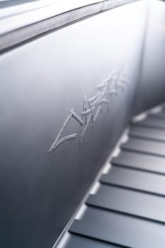 Denver, Colorado, USA-May 5, 2024-This image captures the intricate engraved Tesla logo located inside the open frunk of a Tesla Cybertruck, showcasing the attention to detail and sleek design elements characteristic of Tesla innovative electric vehicles.