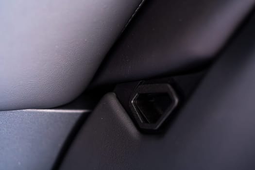 Denver, Colorado, USA-May 5, 2024-This image shows a detailed view of the back seat release pull strap in a Tesla Cybertruck, emphasizing the subtle yet functional design integrated within the vehicle interior.