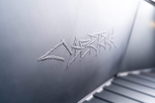 Denver, Colorado, USA-May 5, 2024-This image captures the intricate engraved Tesla logo located inside the open frunk of a Tesla Cybertruck, showcasing the attention to detail and sleek design elements characteristic of Tesla innovative electric vehicles.