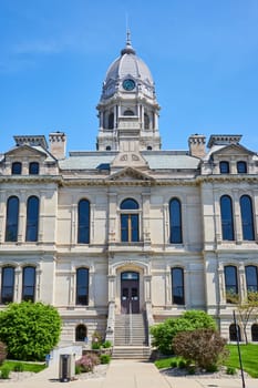 Majestic Kosciusko County Courthouse under clear blue skies, symbolizing stability and architectural elegance.