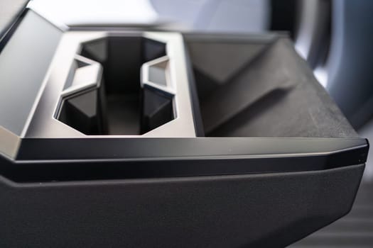 Denver, Colorado, USA-May 5, 2024-This image captures the innovative design of the cupholder inside the Tesla Cybertruck, showcasing its unique angular shapes and modern, minimalist aesthetic.