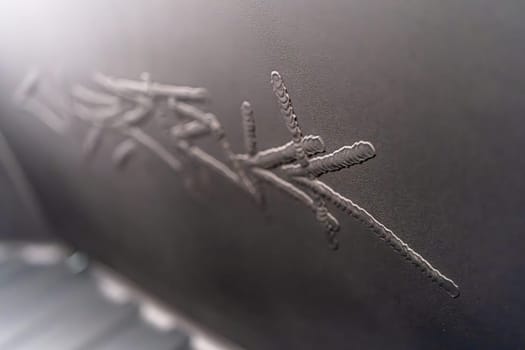 Denver, Colorado, USA-May 5, 2024-This image captures the intricate engraved Tesla logo located inside the open frunk of a Tesla Cybertruck, showcasing the attention to detail and sleek design elements characteristic of Tesla innovative electric vehicles.