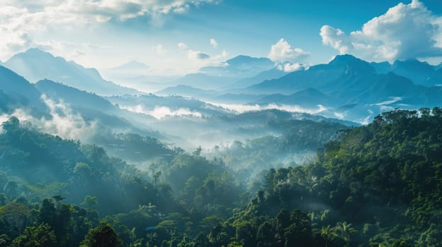 A panoramic vista of a tropical mountain range, with mist-shrouded peaks rising majestically against a backdrop of clear blue skies, offering a glimpse into the awe-inspiring grandeur of untouched.