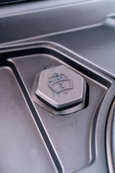 Denver, Colorado, USA-May 5, 2024-This image shows a detailed close-up of the windshield washer fluid cap in a Tesla Cybertruck, highlighting the unique design and branding elements typical of Tesla innovative approach to car manufacturing.