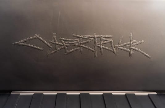 Denver, Colorado, USA-May 5, 2024-This image captures the intricate engraved Tesla logo located inside the open frunk of a Tesla Cybertruck, showcasing the attention to detail and sleek design elements characteristic of Tesla innovative electric vehicles.