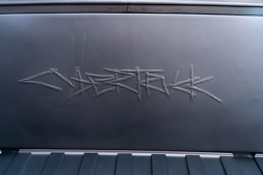 Denver, Colorado, USA-May 5, 2024-This image captures the intricate engraved Tesla logo located inside the open frunk of a Tesla Cybertruck, showcasing the attention to detail and sleek design elements characteristic of Tesla innovative electric vehicles.