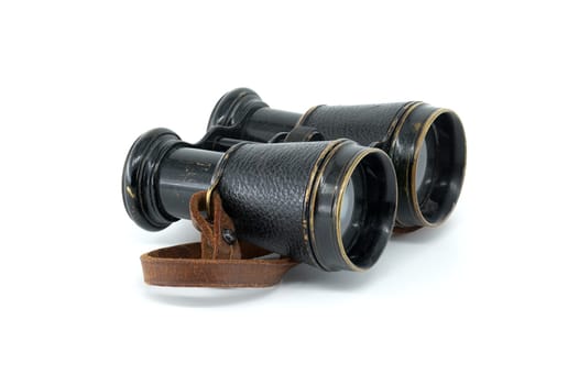 A pair of antique black binoculars with brown leather straps is showcased against a white background