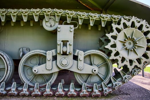 Close-up of a military tank track and wheel assembly in Warsaw, Indiana, showcasing robust engineering.