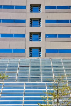 Modern architecture in downtown Fort Wayne showcasing a blend of concrete and reflective glass under a clear sky.